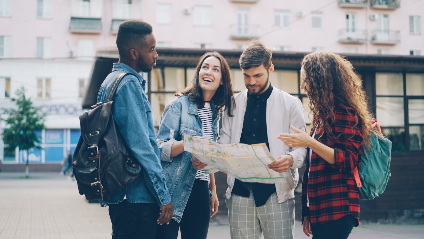 Friends reviewing a city map and discussing their journey